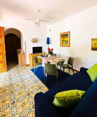 a living room with a couch and a table at Casa a Mare La Stalletta in Palermo