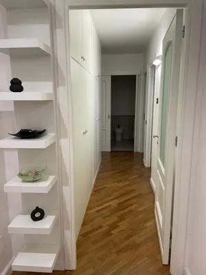 a hallway with white shelves in a white room at Baaria house in Bagheria