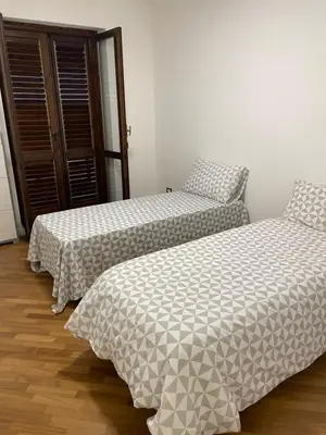 two beds sitting next to each other in a room at Baaria house in Bagheria