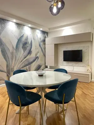 a dining room with a white table and blue chairs at Baaria house in Bagheria