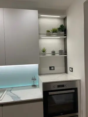 a kitchen with a counter with plants on shelves at Baaria house in Bagheria