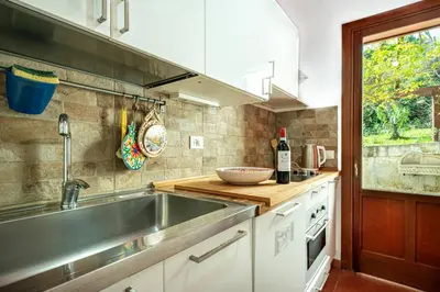 a kitchen with a sink and a counter top at Villa Acquamarina - 300 meters from the sea in Scopello