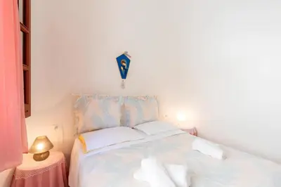 a bedroom with a bed with a kite on the wall at Casa Vacanze Maria in San Vito lo Capo