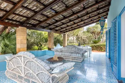 a patio with two couches and a fire pit at Mille e Una Notte By Domus Sicily in Mondello