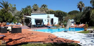 a swimming pool in front of a house at Mille e Una Notte By Domus Sicily in Mondello