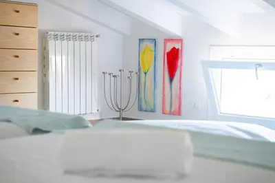 a bedroom with a bed and paintings on the wall at Villa Majestatis con piscina privata in Scopello