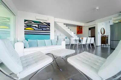 a living room with white furniture and a table at Villa Majestatis con piscina privata in Scopello