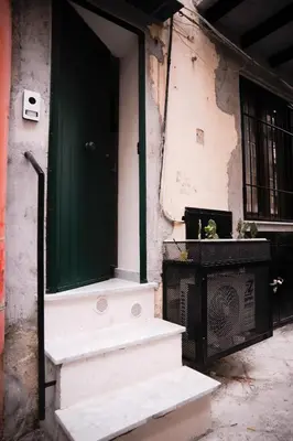 an entrance to a building with a green door and stairs at 4 Canti Central Loft & Ground floor in Palermo