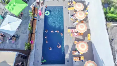 an overhead view of a swimming pool with people on it at Ostello Bello Palermo in Palermo