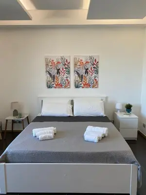 a bedroom with a bed with two towels on it at Villa Rubino in Isola delle Femmine