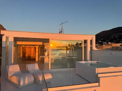 a balcony of a house with white furniture on it at Attico sul Mare - Suite & Spa in Palermo