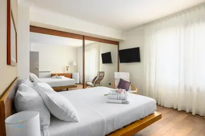 a bedroom with a large bed with white pillows at Verosicily Villa Barcellona in Terrasini