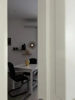a white table and chairs in a room at Maquè apartments in Palermo