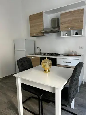 a kitchen with a white table and two chairs at Maquè apartments in Palermo