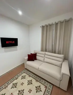 a living room with a white couch with red pillows at Maquè apartments in Palermo