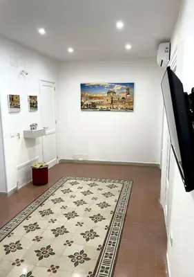 a living room with a rug on the floor at Maquè apartments in Palermo