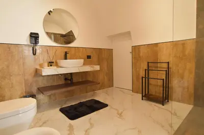 a bathroom with a sink and a mirror on the wall at FLA' Suite Deluxe in Terrasini