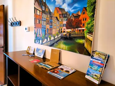 a desk in a room with a painting on the wall at La Finestra sul Golfo in Castellammare del Golfo