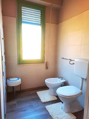 a bathroom with a toilet and a bidet and a window at La Finestra sul Golfo in Castellammare del Golfo