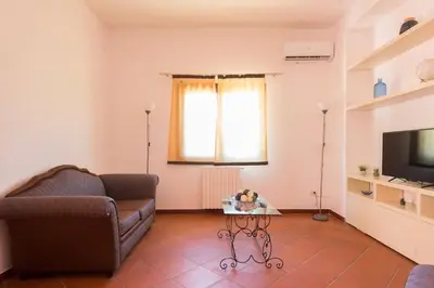 a living room with a couch and a table at Villetta Milù in Palermo