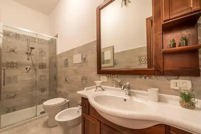 a bathroom with a sink and a toilet and a shower at Villetta Milù in Palermo