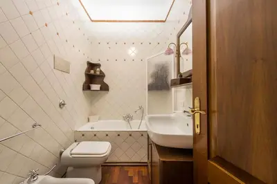 a bathroom with a toilet and a sink at Villetta Milù in Palermo