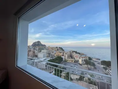 a view from a window of a city and the ocean at Bellavista in Santa Flavia