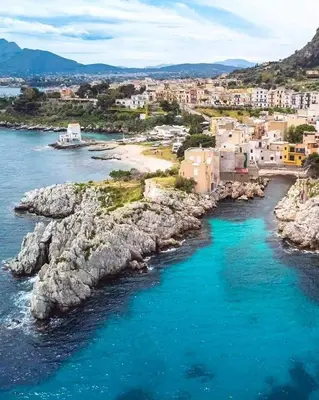 an aerial view of a beach with buildings and the ocean at Bellavista in Santa Flavia