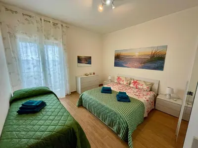 a bedroom with two beds and a window at Bellavista in Santa Flavia