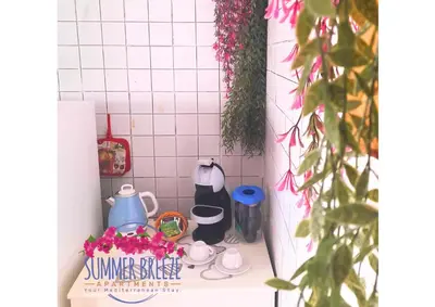 a kitchen counter with a bunch of flowers on it at Summer Breeze Apartments in Trappeto