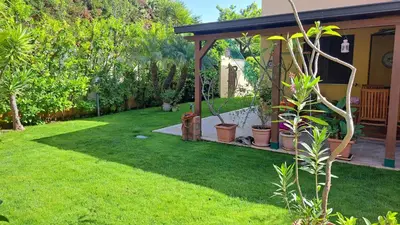 a garden with a gazebo and plants in a yard at Villa Agae in Trabia