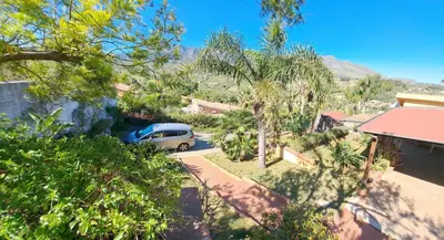 a van parked in the driveway of a house at Villa Agae in Trabia