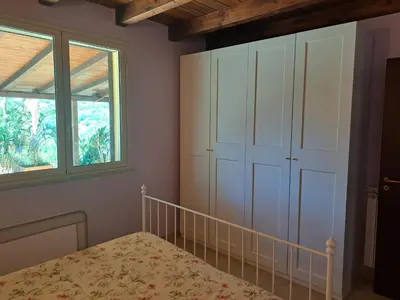 a bedroom with a bed and a window at Villa Agae in Trabia