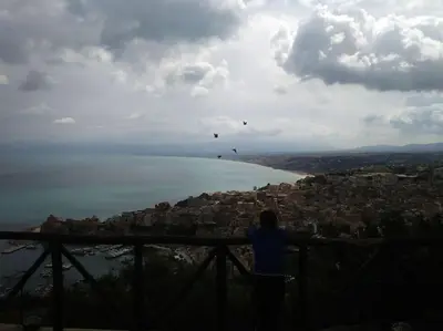 a person standing on top of a hill looking at the water at A 2 passi dal castello ,appartamento con veranda in Castellammare del Golfo