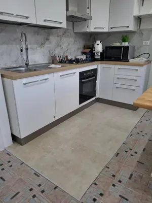a kitchen with white cabinets and a sink at Ricky House in Palermo