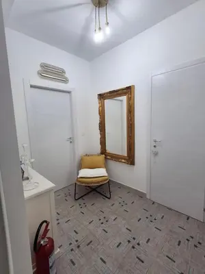 a hallway with white walls and a wooden floor at Ricky House in Palermo