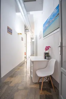 a room with a window and a desk with a plant at ROME 118 intero appartamento in Palermo