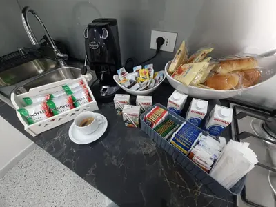 a counter with breakfast food and a cup of coffee at Private House 14 Palermo in Palermo