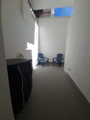 a hallway with two blue chairs and a table at Private House 14 Palermo in Palermo