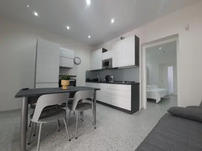 a kitchen and dining room with a table and chairs at Private House 14 Palermo in Palermo