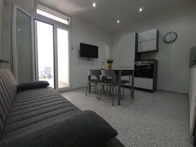 a living room with a couch and a dining room table at Private House 14 Palermo in Palermo