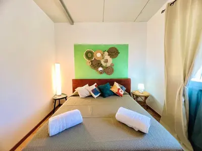 a bedroom with a bed with a painting on the wall at Tri Ri Coppe in Cinisi