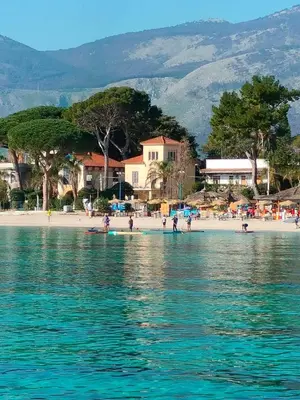 a group of people on a beach near the water at Villa Costa Mondello in Palermo
