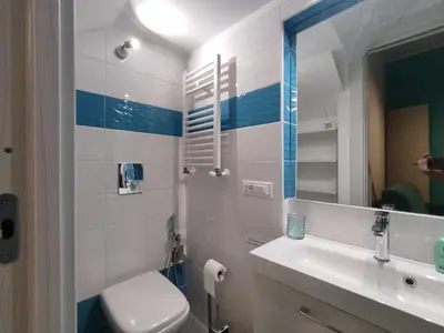 a bathroom with a toilet and a sink and a mirror at Casa vacanze Haliotis in Isola delle Femmine