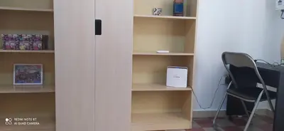 a book shelf with a black chair in a room at Star Apartment at the Cathedral in Palermo