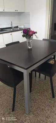 a black table with a vase of flowers on it at Star Apartment at the Cathedral in Palermo