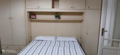 a small bed in a room with white cabinets at Star Apartment at the Cathedral in Palermo