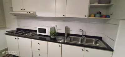 a kitchen counter with a sink and a microwave at Star Apartment at the Cathedral in Palermo