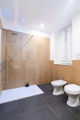 a bathroom with a shower and a toilet and a sink at Picciridda Rooms in Palermo