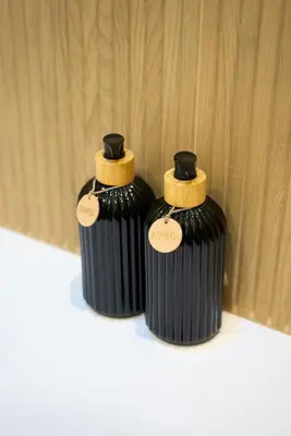 two black containers sitting on top of a table at Picciridda Rooms in Palermo